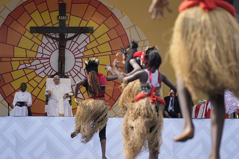 Pope Francis (second from left) looks at traditional dancers performing Thursday at the Martyrs’ Stadium In Kinshasa, Democratic Republic of Congo.
(AP/Gregorio Borgia)