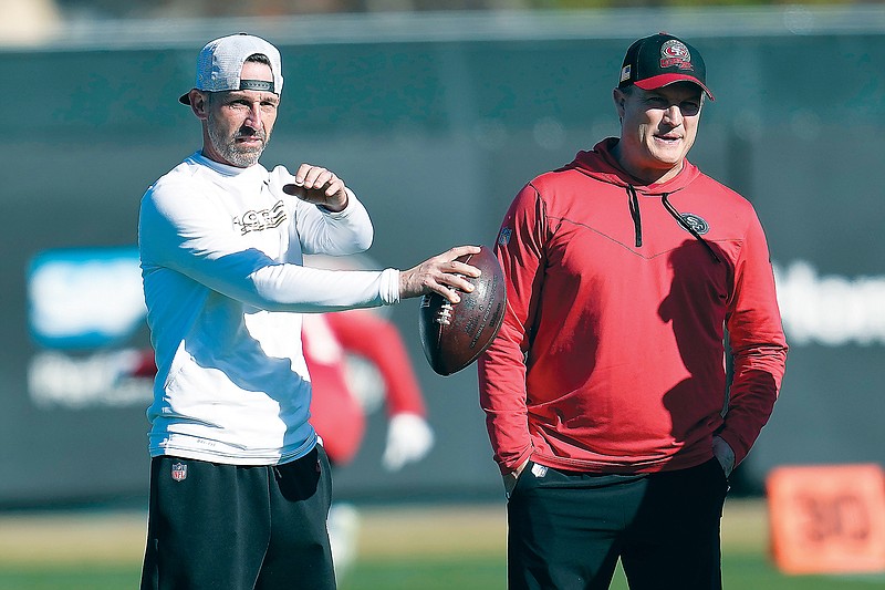 Niners head coach Kyle Shanahan (left) and general manager John Lynch watch as players take part in drills last week in Santa Clara, Calif. (Associated Press)