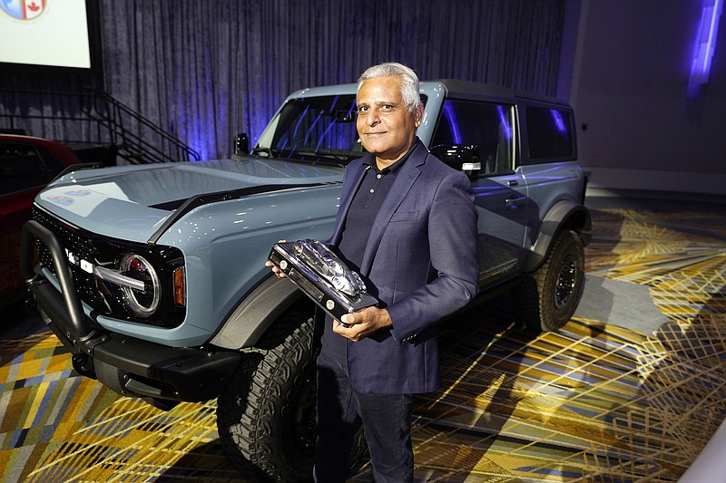 Kumar Galhotra, president of Ford Blue, the company's internal-combustion business, poses next to a Bronco sport utility vehicle last month in Detroit.
(AP/Carlos Osorio)