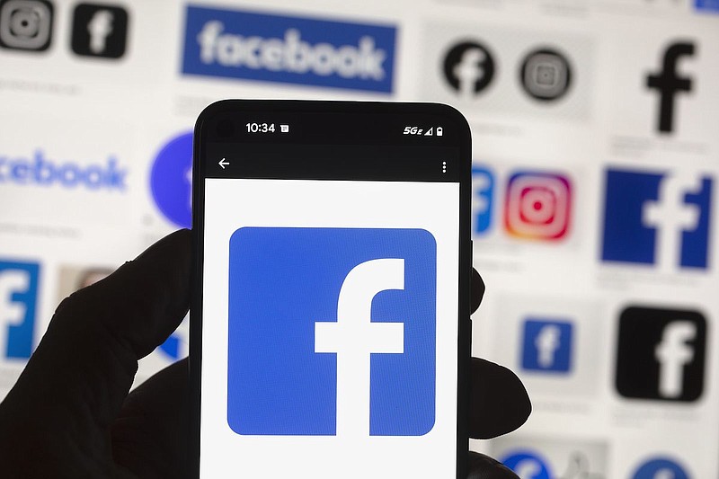 The Facebook logo is seen on a cell phone, Friday, Oct. 14, 2022, in Boston. Facebook parent Meta is reinstating former President Donald Trump's personal account after two-year suspension following the Jan. 6 insurrection. (AP Photo/Michael Dwyer, File)