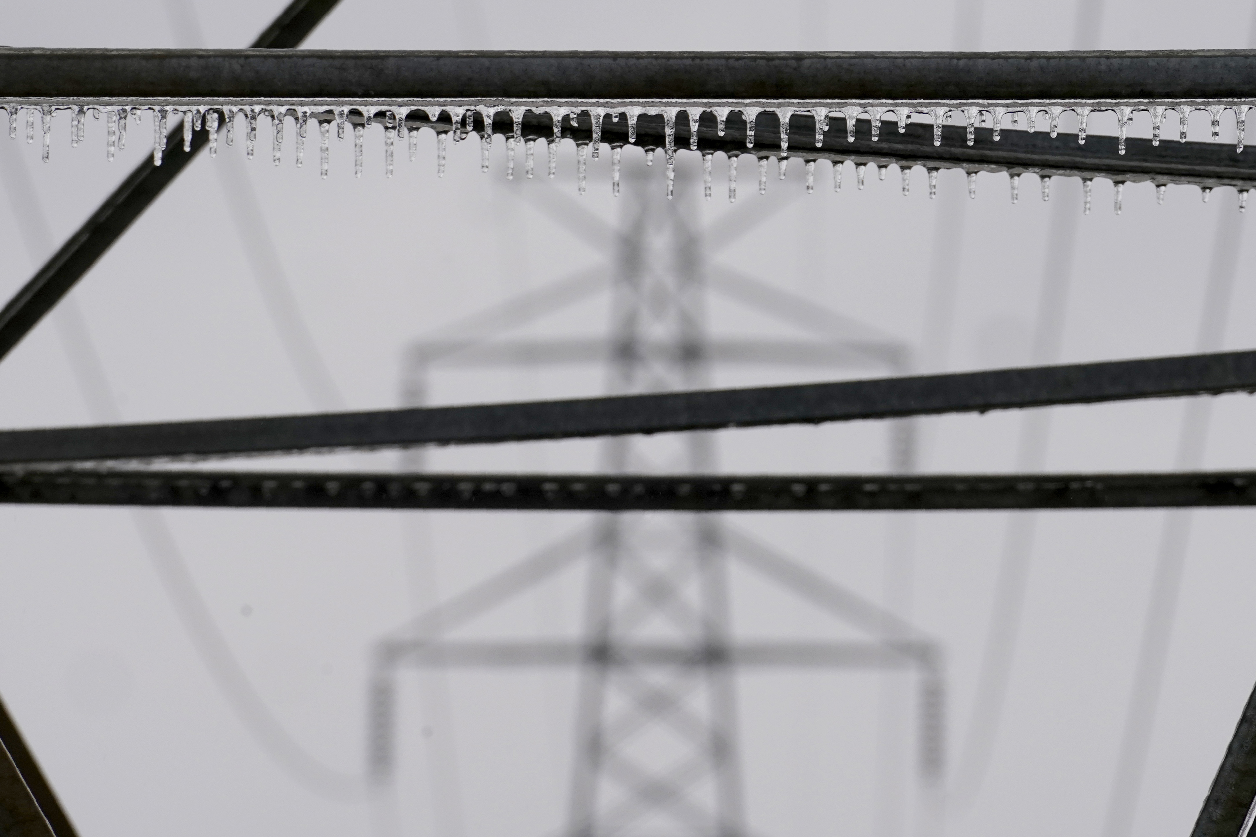 Icicles that formed on a power line structure from a few days of rain and sleet can been seen, Thursday, Feb. 2, 2023, in Dallas. (AP Photo/Tony Gutierrez)