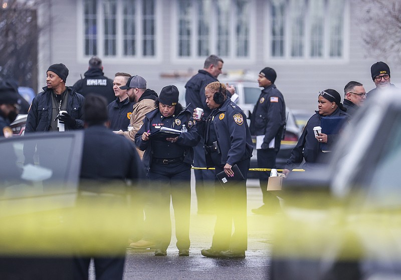 Law enforcement personnel work at the scene of a shooting at a Tennessee library, Thursday, Feb. 2, 2023, in Memphis.  Authorities say one person is dead and a police officer was critically wounded. (Patrick Lantrip/Daily Memphian via AP)