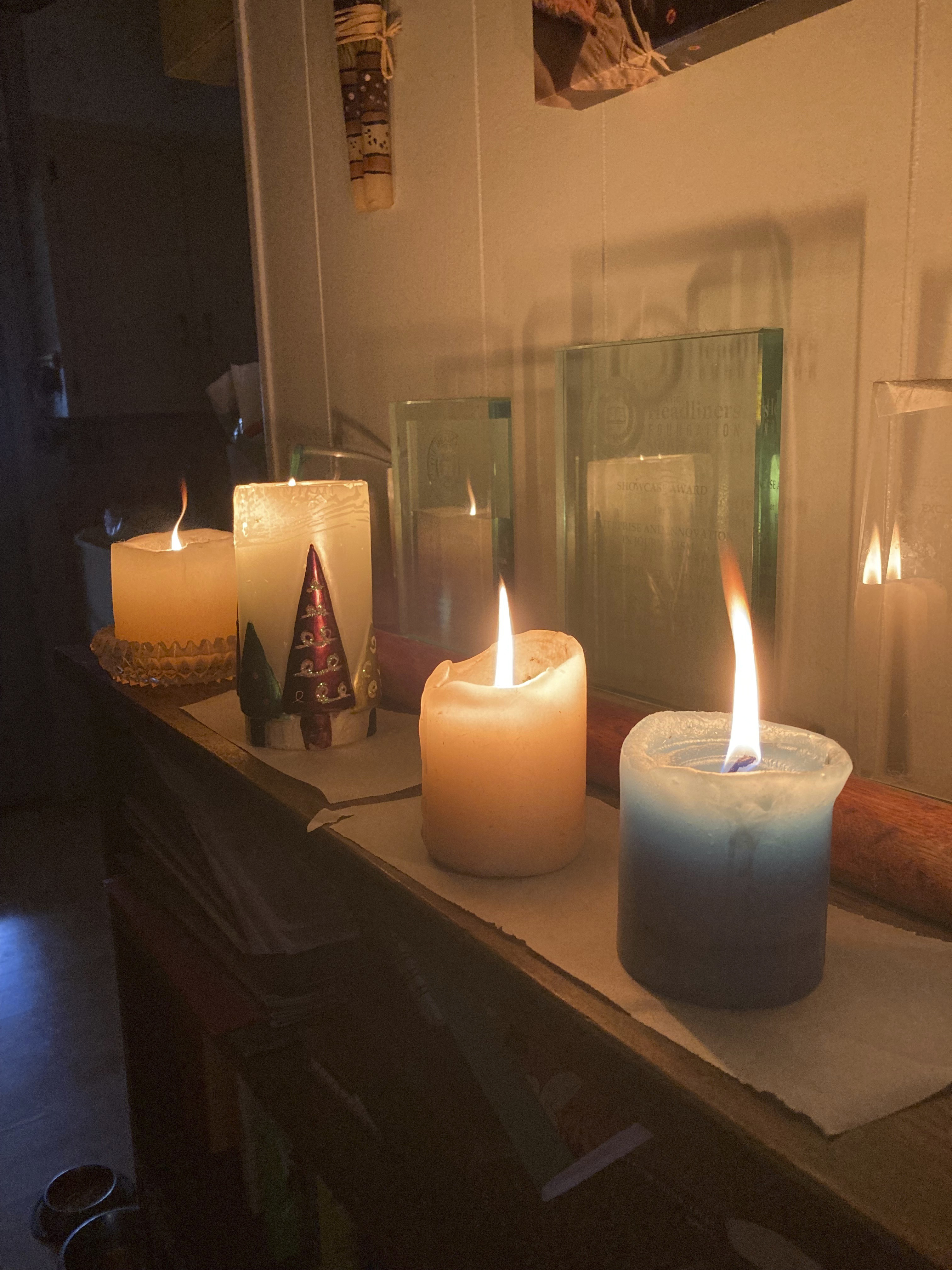 Candles are lit at an Austin, Texas, home, Wednesday, Feb. 1, 2023. A storm knocked out power for a third of the city. Even as temperatures finally pushed above freezing in Austin — and were expected to climb past 50 degrees (10 Celsius) on Friday — the relief will be just in time for an Arctic front to drop from Canada and threaten northern states. (Andrea Ball/Houston Chronicle via AP)