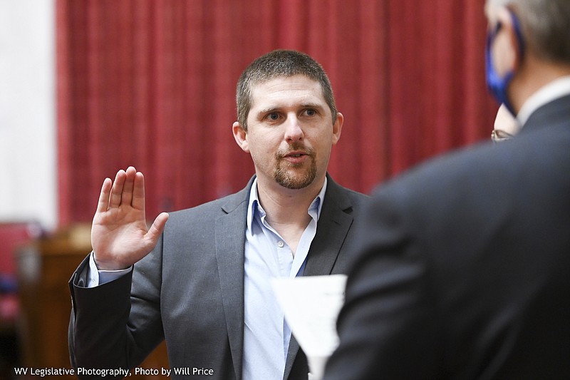 FILE - In this image provided by the West Virginia Legislative Photography, Derrick Evans is shown during his swearing-in ceremony to the West Virginia House of Delegates on Dec. 1, 2020, in Charleston, W.Va. Some Jan. 6 defendants who have expressed remorse in court after joining the pro-Trump mob that stormed the Capitol have later struck a different tone or sought to downplay the riot publicly. After pleading guilty to a felony charge in the riot, former West Virginia lawmaker Derrick Evans told a judge in June that he regrets his actions and takes full responsibility for them. He's now running for Congress (Will Price, West Virginia Legislative Photography via AP)