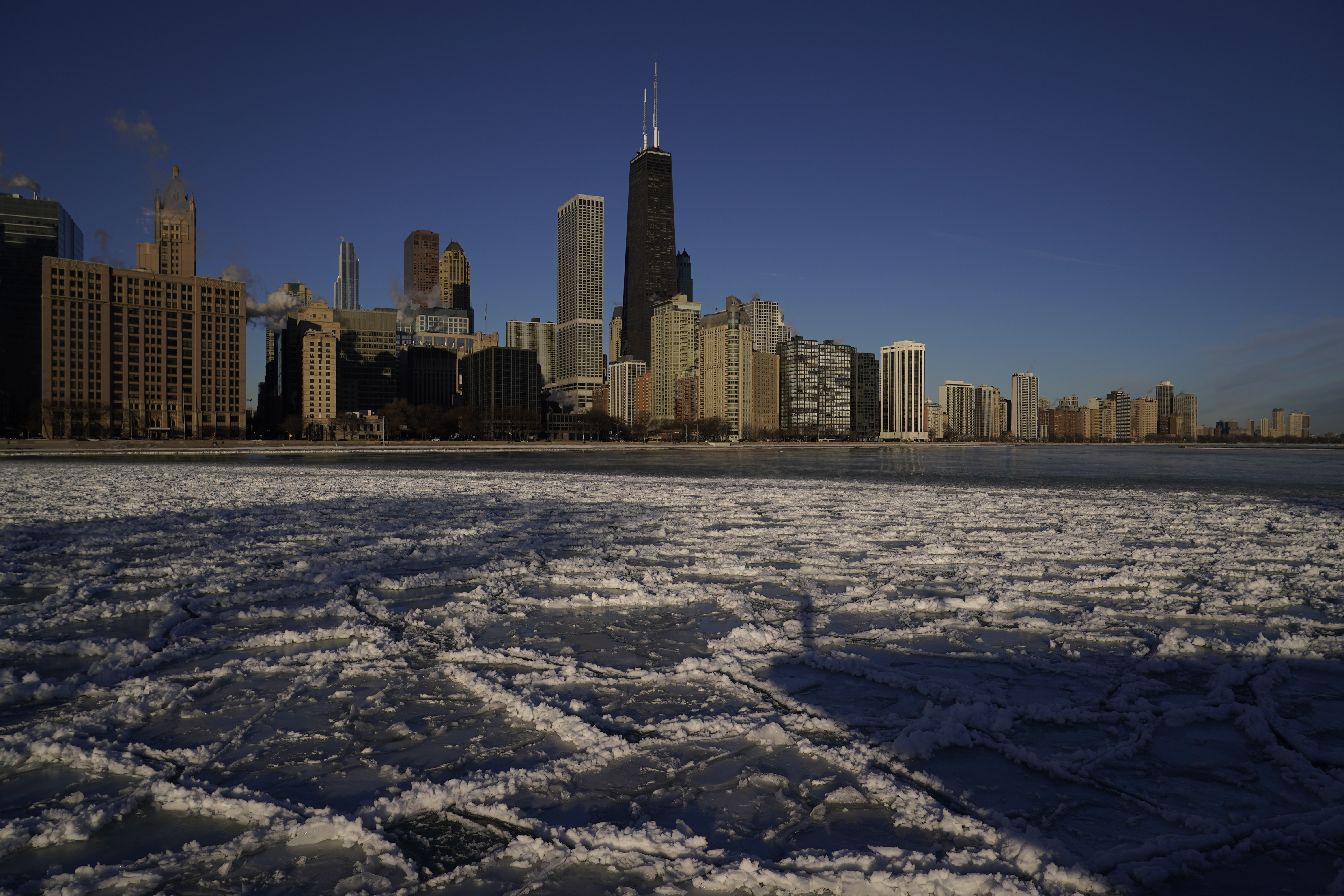 Ice piles up along Ohio Street Beach Friday, Feb. 3, 2023, in downtown Chicago. (AP Photo/Kiichiro Sato)