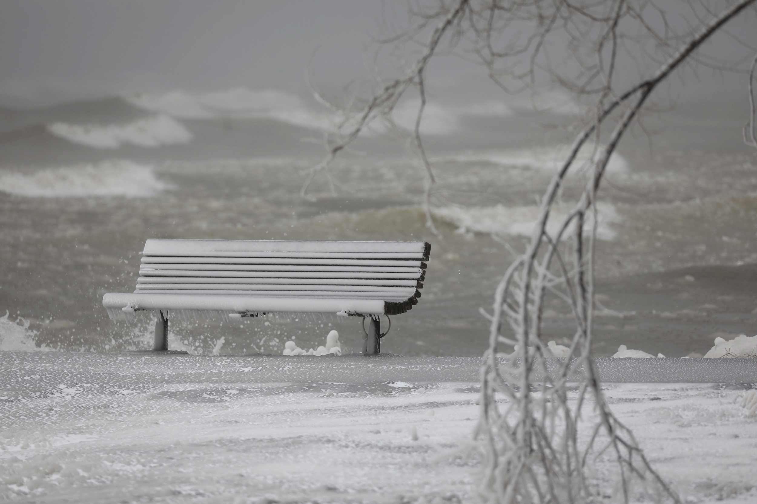 A sheen of ice covers a bench on the pier in Webster Park in Webster, N.Y., on Friday, Feb. 3, 2023. (Tina MacIntyre-Yee/Democrat & Chronicle via AP)