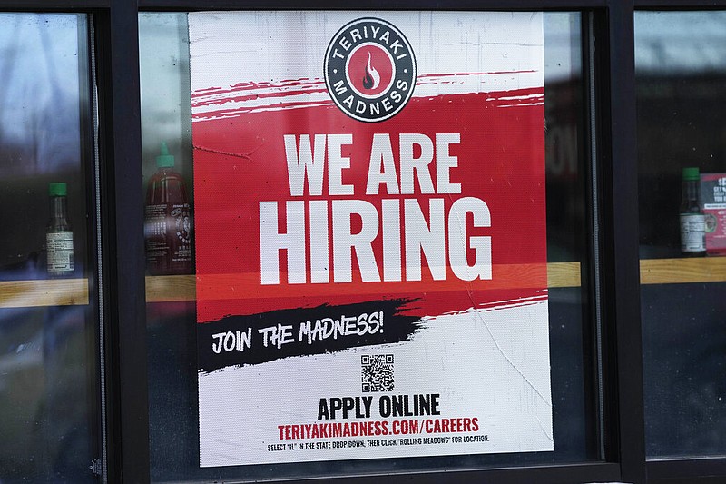 A hiring sign is displayed at a restaurant in Rolling Meadows, Ill., Monday, Jan. 30, 2023. America’s employers added a robust 517,000 jobs in January, a surprisingly strong gain in the face of the Federal Reserve’s aggressive drive to slow growth and tame inflation with higher interest rates. (AP/Nam Y. Huh)