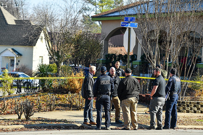 Investigators with the Fort Smith Police Department work, Friday, Feb. 3, 2023, at the site of a shooting death at a residence on the corner of Grand Avenue and 18th Street in Fort Smith. (NWA Democrat-Gazette/Hank Layton)