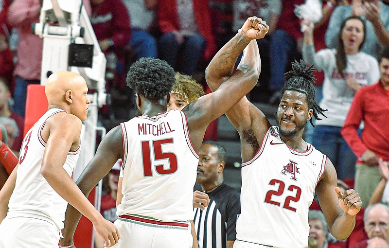 Arkansas forward/centers Makhel Mitchell (22) and Makhi Mitchell (15) celebrate, Wednesday, Jan. 11, 2023, during the first half of the Alabama Crimson Tide’s 84-69 win over the Razorbacks at Bud Walton Arena in Fayetteville. Visit nwaonline.com/photo for today's photo gallery..(NWA Democrat-Gazette/Hank Layton)
