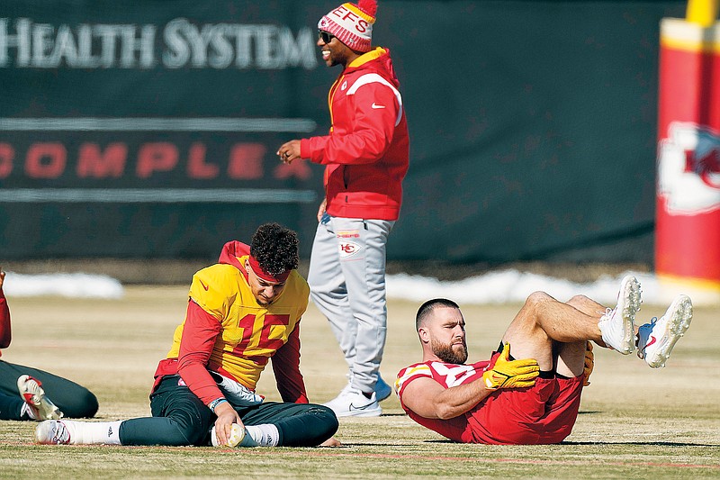 Chiefs quarterback Patrick Mahomes and tight end Travis Kelce stretch Thursday during practice in Kansas City. (Associated Press)
