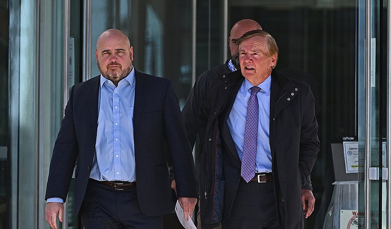 Former state Sen. Jeremy Hutchinson (left) leaves the federal courthouse Friday in Little Rock with
his father, former U.S. Sen. Tim Hutchinson, after sentencing.
(Arkansas Democrat-Gazette/Staci Vandagriff)