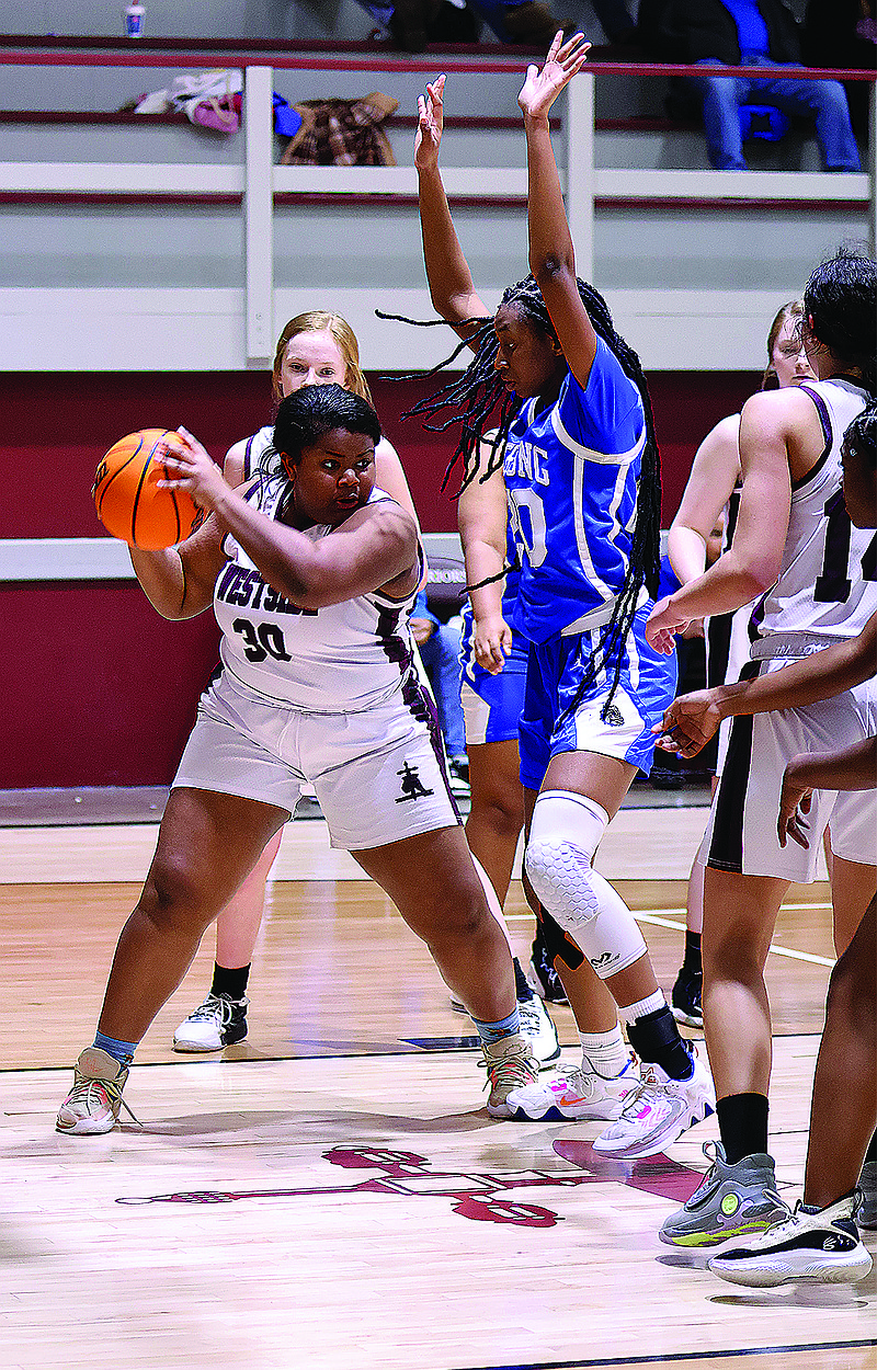 West Side Christian's Vivian Conley is defended by Strong's Kennedi Dixon on Thursday.