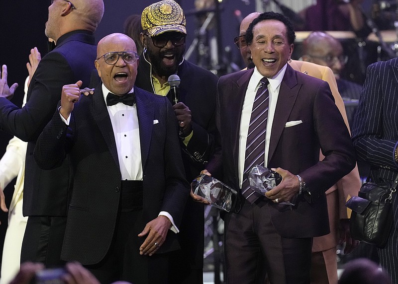 Berry Gordy, left, and Smokey Robinson, right, accept their MusiCares Person of the Year awards at a celebration in their honor at the Los Angeles Convention Center on Friday, Feb. 3, 2023. (AP Photo/Chris Pizzello)