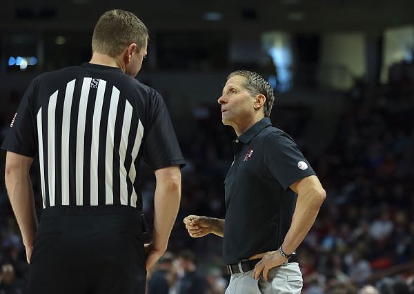 Arkansas coach Eric Musselman (right) speaks to an official during a game Saturday, Feb. 4, 2023, in Columbia, S.C.