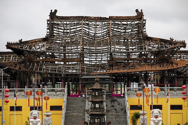 The damaged structure is seen at the scene of a fire at the Bright Moon Buddhist Temple in Springvale South, Melbourne Monday, Feb. 6, 2023. The Buddhist temple in Melbourne was extensively damaged by fire Sunday. About 80 firefighters fought the blaze at the temple. Fire investigators haven’t yet determined the cause. No injuries were reported. (Diego Fedele/AAP Image via AP)