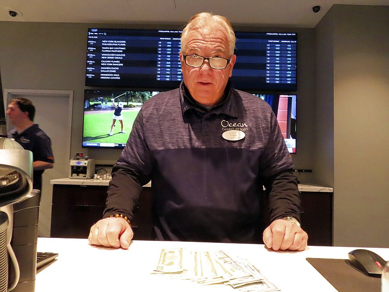 Frank Caltagirone, a sports book employee at the Ocean Casino Resort in Atlantic City, N.J., counts money from his drawer Monday, Feb. 6, 2023. On Feb. 7, 2023, the gambling industry's national trade group, the American Gaming Association, predicted that over 50 million American adults will bet a total of $16 billion on this year's Super Bowl, including legal bets with sports books, illegal ones with bookies, and casual bets among friends or relatives. (AP Photo/Wayne Parry)