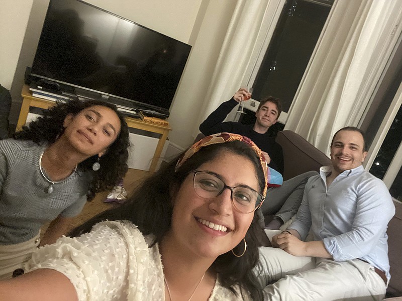 This image provided by Catalina María Gomez Caycedo shows Aleena Rupani, from left, Catalina María Gomez Caycedo, Henry Crabtree, and Michael Watkins in Crabtree's London flat. The close friends met through their work at a software company with workers scattered around the globe. A recent Gallup survey says just 2 in 10 adult U.S. employees say they have a best friend at work. (Catalina María Gomez Caycedo via AP).