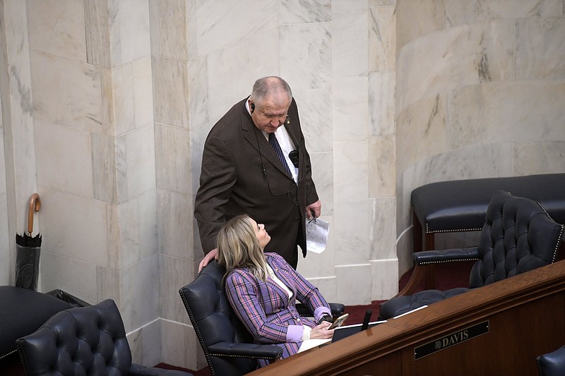 Sen. David Wallace, R-Leachville, talks with Sen. Breanne Davis, R-Russelville, after introducing a bill that would revamp the system for making appointments to the state Plant Board during a meeting of the Senate at the state Capitol on Wednesday.
(Arkansas Democrat-Gazette/Stephen Swofford)