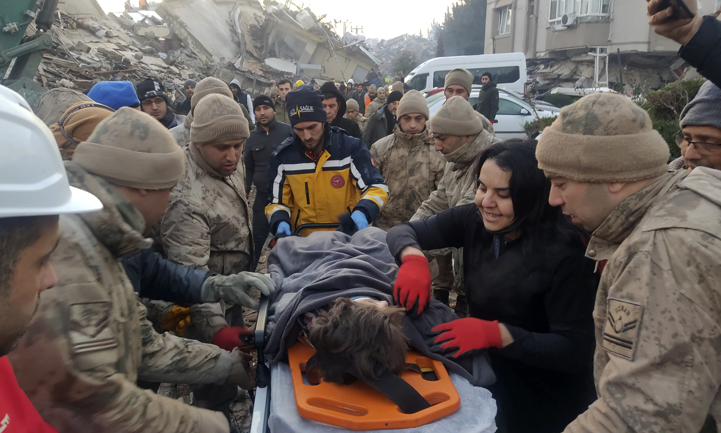 Turkish army commandos rescue Kübra, a ten-year-old girl, from under the rubble in Hatay, southern Turkey, Wednesday, Feb. 8, 2023. Freezing cold temperatures are hindering rescue teams as they work to save people still trapped in the rubble after a 7.8-magnitude earthquake ripped through the region in the early morning hours Monday. Officials expect the number of reported deaths to increase significantly as operations continue. (IHA via AP)