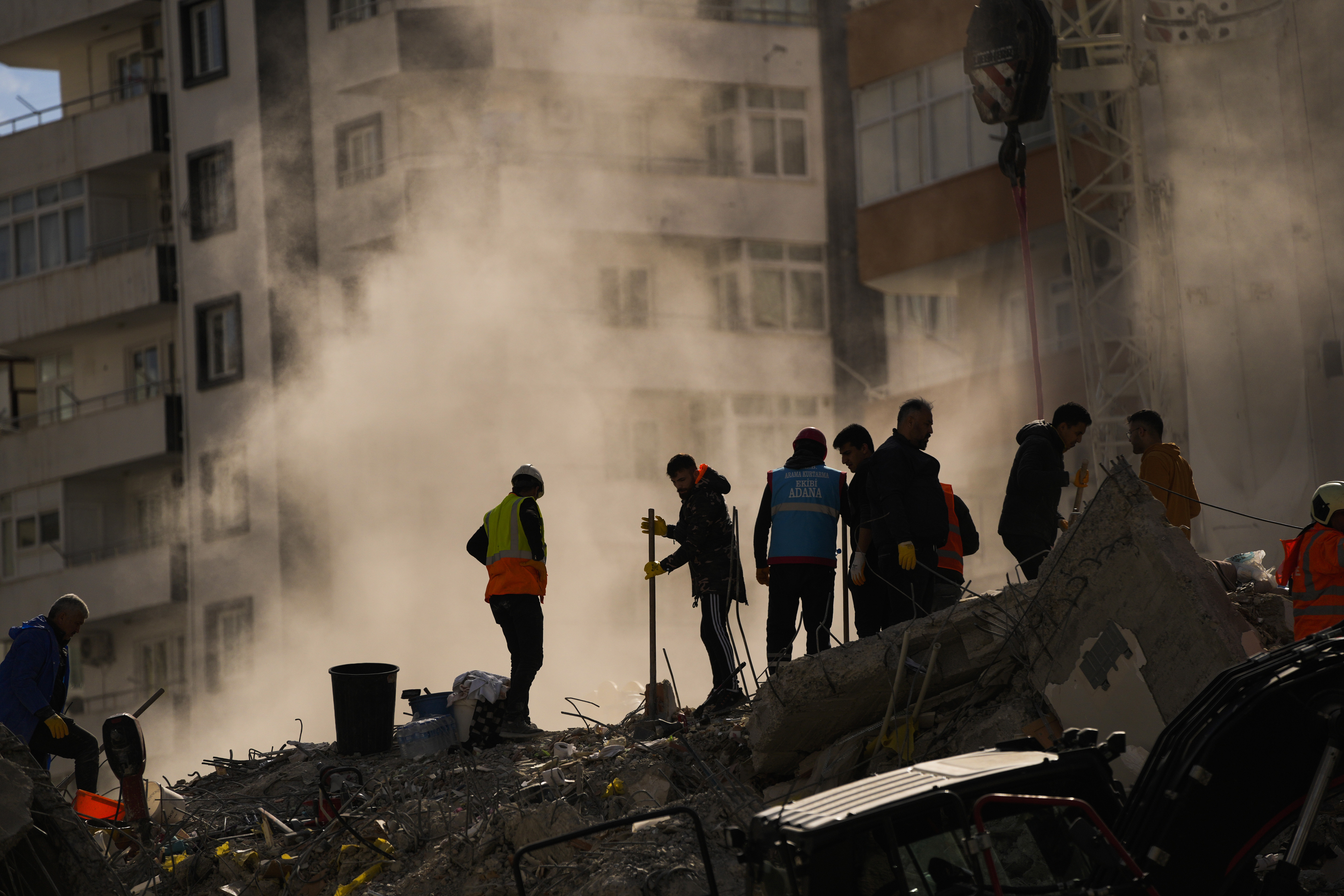 Emergency team members search for people in a destroyed building in Adana, Turkey, Tuesday, Feb. 7, 2023. Rescuers raced Tuesday to find survivors in the rubble of thousands of buildings brought down by a powerful earthquake and multiple aftershocks that struck eastern Turkey and neighbouring Syria. (AP Photo/Francisco Seco)