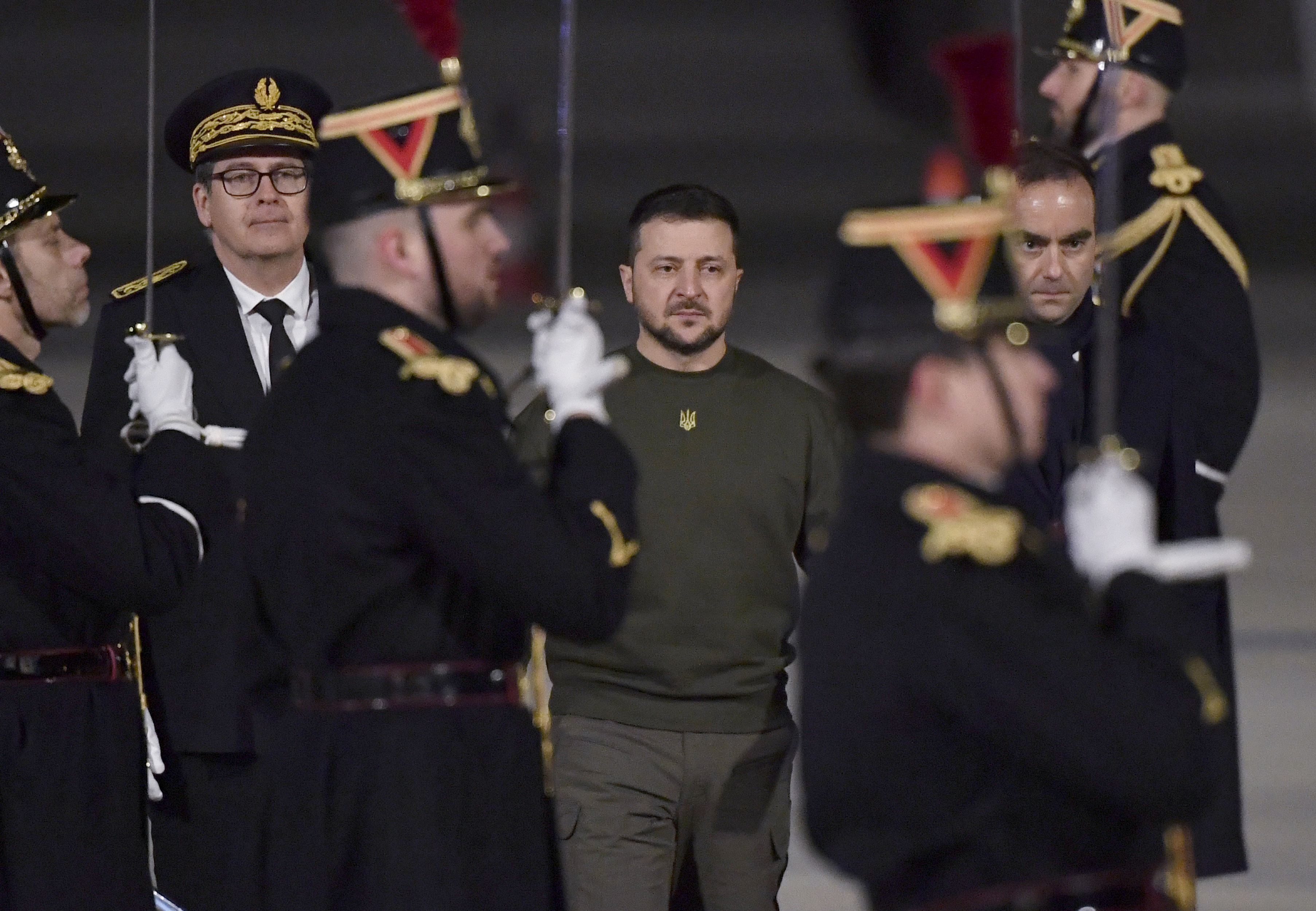 Ukrainian President Volodymyr Zelenskyy, center, andFrench Defense Minister Sebastien Lecornu, right, walk on the tarmac of the Orly airport, south of Paris, Wednesday, Feb. 8, 2023. Ukrainian President Volodymyr Zelenskyy will later have a working diner with French President Emmanuel Macron and German Chancellor Olaf Scholz at the Elysee Palace (Julien de Rosa, pool via AP)