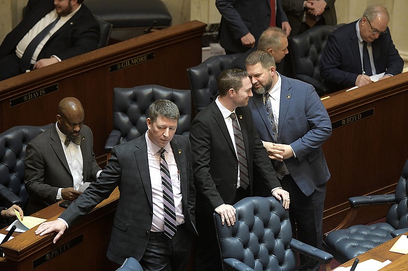 Sens. Joshua Bryant (from left), R-Rogers, Tyler Dees, R-Siloam Springs, and Jim Dotson, R-Bentonville, talk at their desks during a meeting of the Senate at the state Capitol on Wednesday.
(Arkansas Democrat-Gazette/Stephen Swofford)