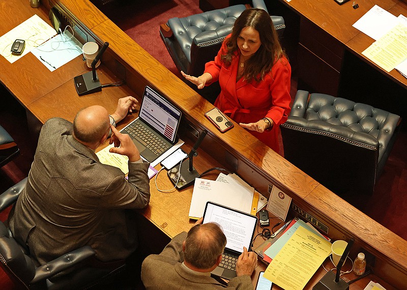 Sen. Missy Irvin, R-Mountain View at top right, talks with Sen. John Payton, R-Wilburn at left, and Sen. Ronald Caldwell, R-Wynne, before the start of a session of the Arkansas state Senate at the Capitol on Tuesday, Feb. 7, 2023. (Arkansas Democrat-Gazette/Colin Murphey)