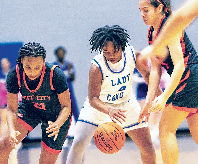 Danijah Fluellen of Capital City tries to control the ball between Jefferson City teammates Emmarie Graham (left) and Izzy Schmidt during Tuesday night's game at Capital City High School. (Josh Cobb/News Tribune)