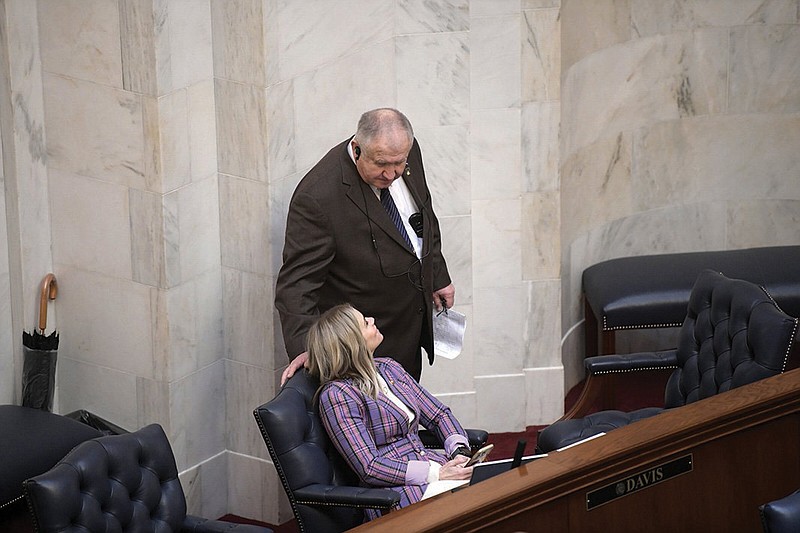 State Sen. David Wallace talks with Sen. Breanne Davis, R-Russellville, in the Senate chamber on Wednesday. At Gov. Sarah Huckabee Sanders’ request, Wallace has filed a proposed constitutional amendment that would provide rights for victims of criminal offenses or delinquent acts. The proposal, to be known as “Marsy’s Law,” is one of 33 proposed constitutional amendments offered by state lawmakers.
(Arkansas Democrat-Gazette/Stephen Swofford)
