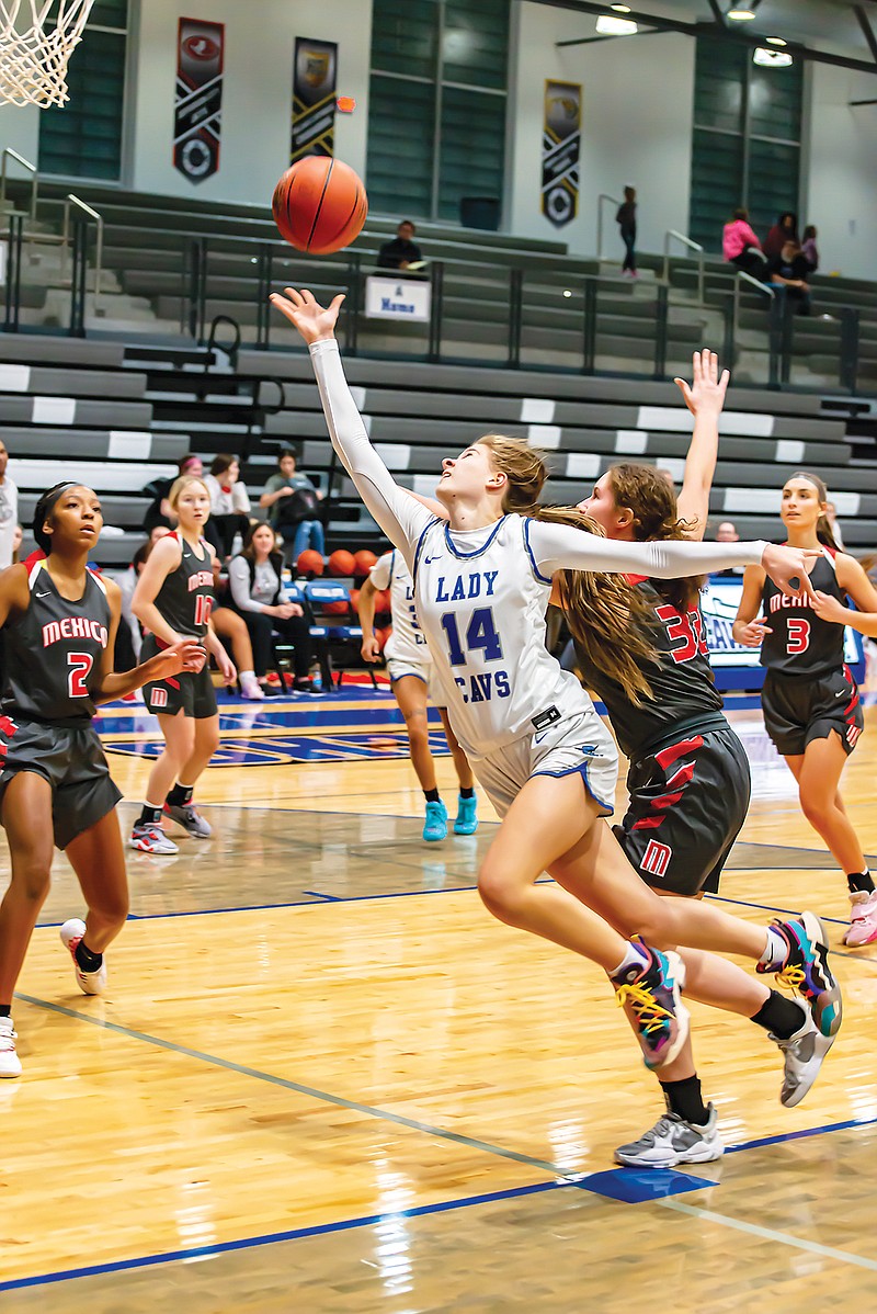 Capital City's Aslyn Marshall puts up a shot while drawing contact during Friday night’s game against Mexico at Capital City High School. (Ken Barnes/News Tribune)