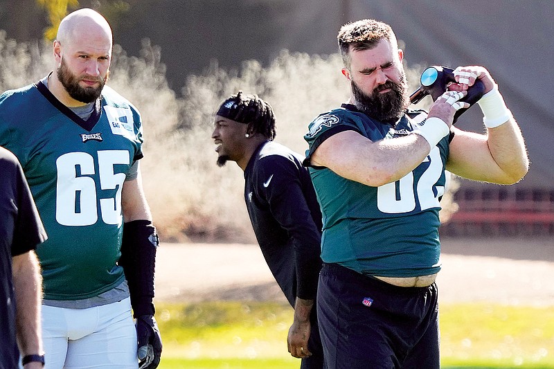 Eagles center Jason Kelce (62) and offensive tackle Lane Johnson (65) warm up before practice Wednesday in Tempe, Ariz. (Associated Press)