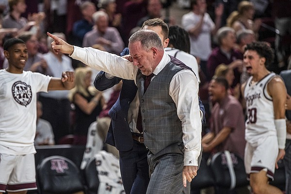 Texas A&M coach Buzz Williams celebrates a score against Arkansas during an NCAA college basketball game in College Station, Texas, Wednesday, Feb. 15, 2023. (Meredith Seaver/College Station Eagle via AP)