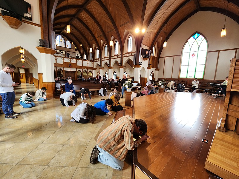 Staff photo by Andrew Schwartz / Lee University students and community members pray and worship at the Lee University chapel Wednesday — two days into an apparently spontaneous prayer event students are calling a revival.