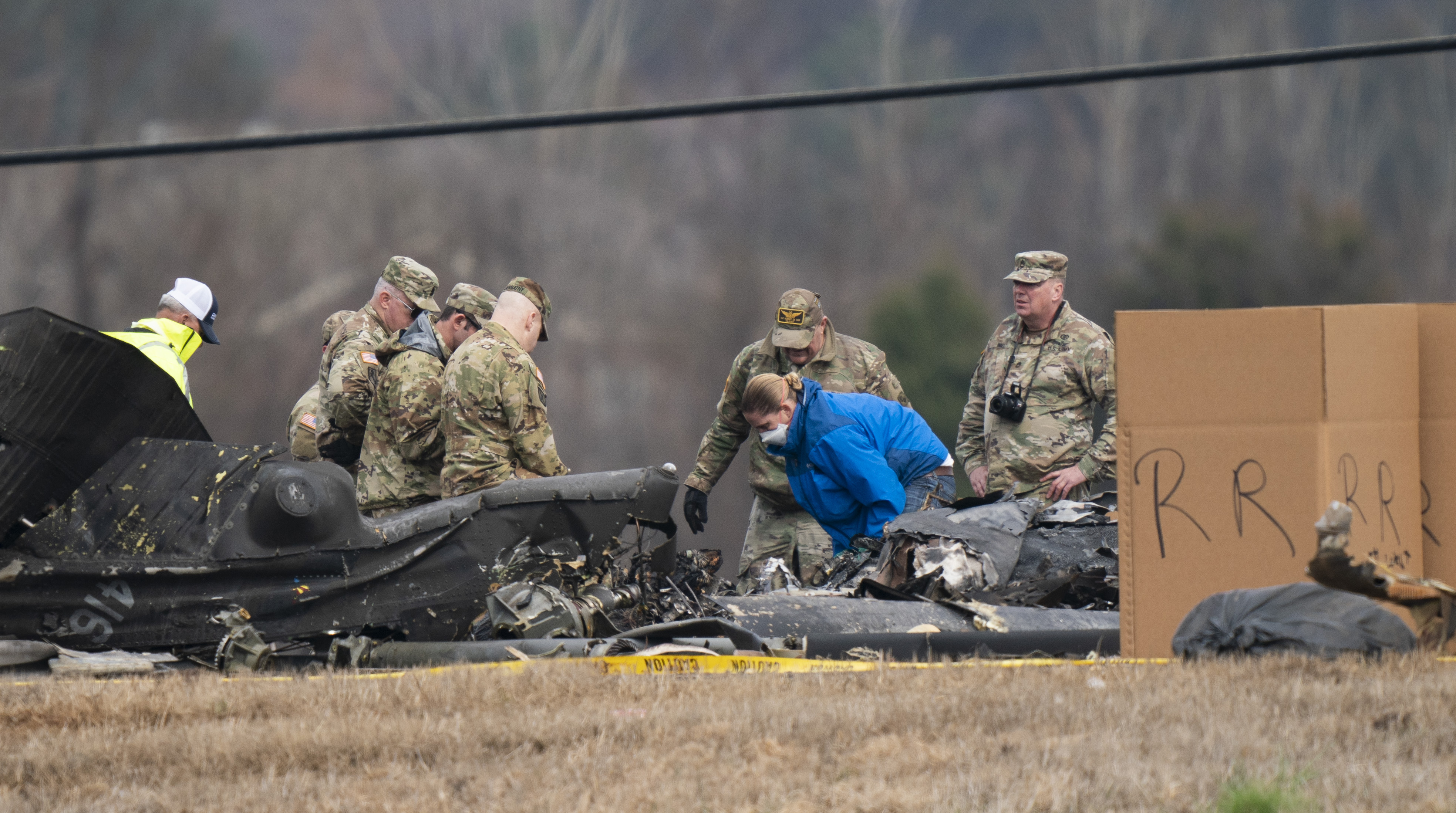 Military personnel and investigators search through debris from a Tennessee National Guard Blackhawk helicopter crash that killed some crew members Thursday, Feb. 16, 2023 in Harvest, Ala. Brig. Gen. Warner Ross said Wednesday that two members of the Tennessee National Guard were killed during a flight-training mission. (George Walker IV/The Tennessean via AP)