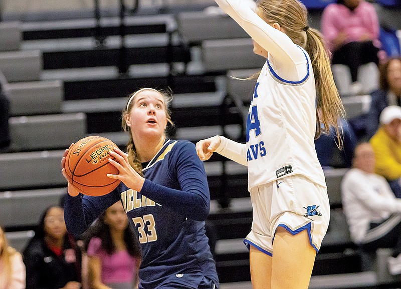 Adalyn Koelling of Helias looks to shoot against the defense of Capital City's Aslyn Marshall during Wednesday night’s game at Capital City High School. (Josh Cobb/News Tribune)
