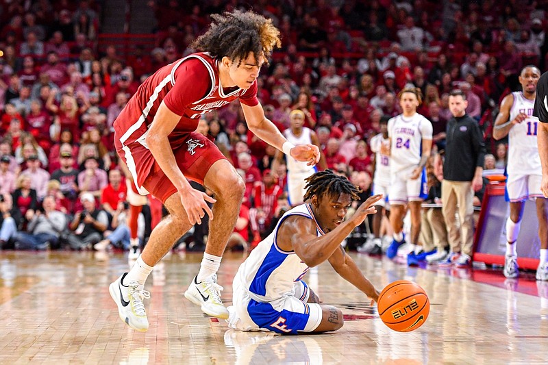 Arkansas guard Anthony Black (0) and Florida guard Trey Bonham (2) compete for a loose ball after Black poked it away on Saturday, Feb. 18, 2023, during the second half of the Razorbacks’ 84-65 win over the Gators at Bud Walton Arena in Fayetteville.
