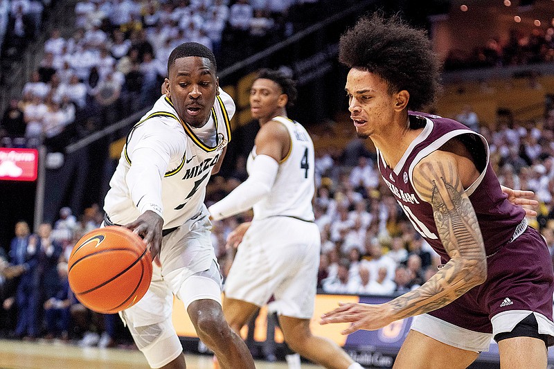 Missouri's D’Moi Hodge tips the ball away from Texas A&M’s Andersson Garcia during Saturday’s game at Mizzou Arena in Columbia. (Associated Press)