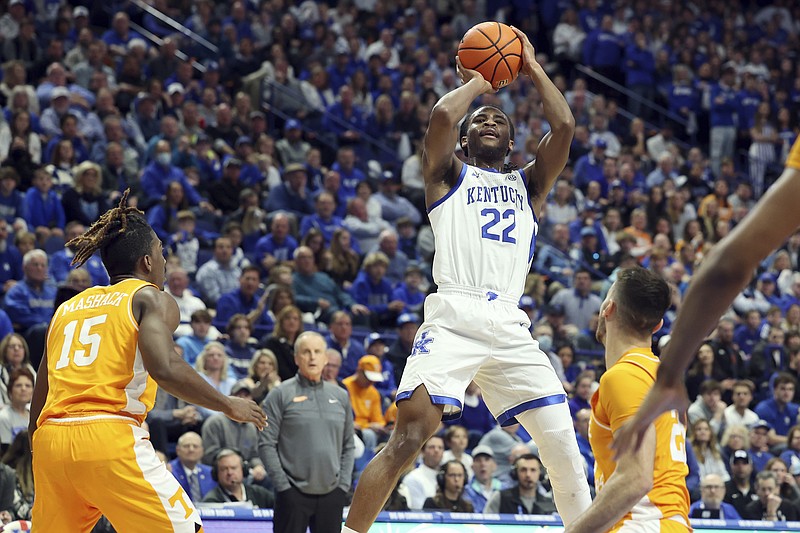 Kentucky's Cason Wallace (22) shoots between Tennessee's Jahmai Mashack (15) and Santiago Vescovi (25) during the first half of an NCAA college basketball game in Lexington, Ky., Saturday, Feb. 18, 2023. (AP Photo/James Crisp)