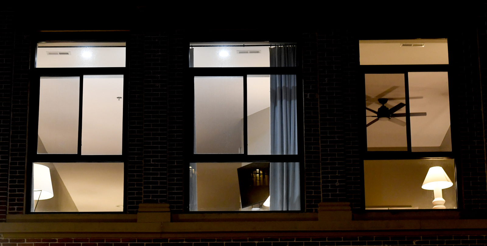 Staff Photo by Robin Rudd / Three windows look out onto the predawn dark on Main Street on February 21, 2023.