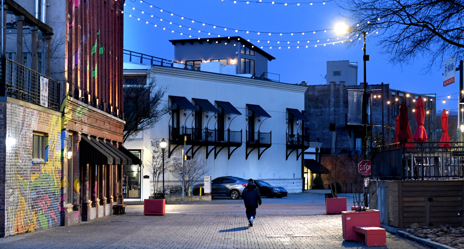 Staff Photo by Robin Rudd / A man walks down Station Street before dawn, next to the Choo Choo, on February 21, 2023.