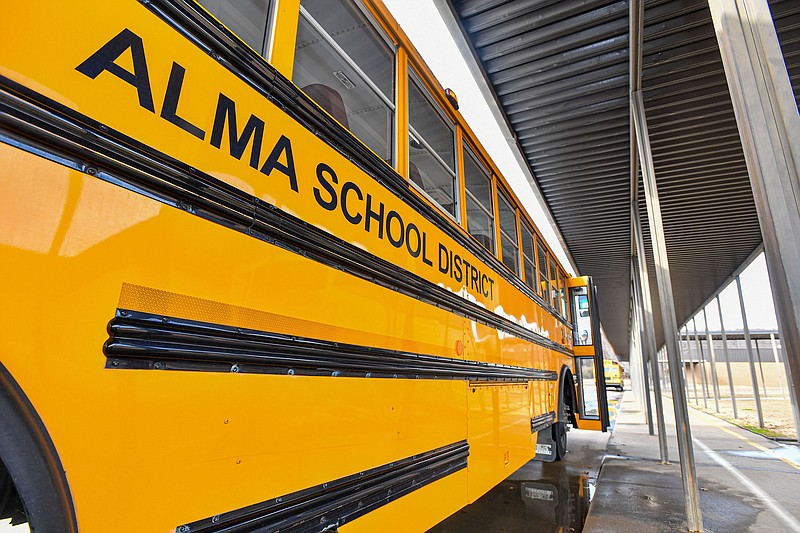 The exterior of a school bus is seen, Thursday, Feb. 16, 2023, at Alma Primary School in Alma. Alma Public Schools received a grant to replace their 30-year-old buses with electric ones, which are expected to be ready in the fall. Visit nwaonline.com/photo for today's photo gallery..(NWA Democrat-Gazette/Hank Layton)