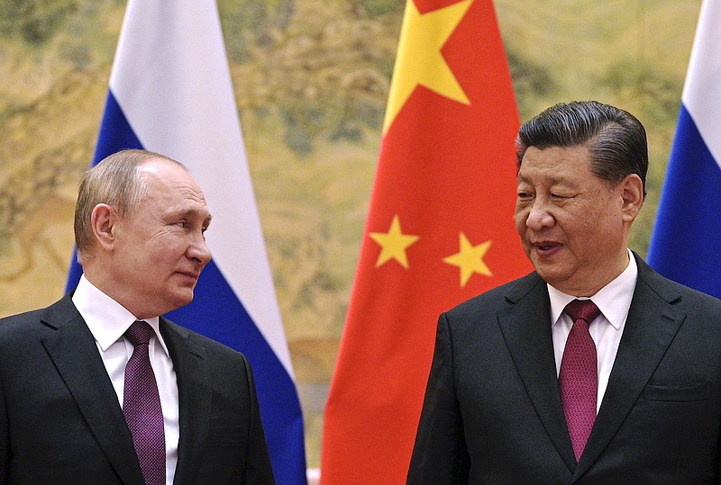 FILE - Chinese President Xi Jinping, right, and Russian President Vladimir Putin talk to each other during their meeting in Beijing, China on Feb. 4, 2022. Just weeks before the Feb. 24, 2022, invasion, Xi hosted Putin in Beijing for the opening of the Winter Olympics, at which time the sides issued a joint statement pledging their commitment to a "no limits" friendship. China has since ignored Western criticism and reaffirmed that pledge, underscoring how the two countries have aligned their foreign policies to oppose the liberal international world order led by the United States and its democratic allies. (Alexei Druzhinin, Sputnik, Kremlin Pool Photo via AP, File)