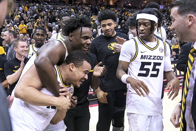 Nick Honor is hugged by Missouri teammate Kobe Brown as Sean East II watches after Honor’s game-winning basket in overtime in Tuesday night’s game against Mississippi State at Mizzou Arena in Columbia. (Associated Press)