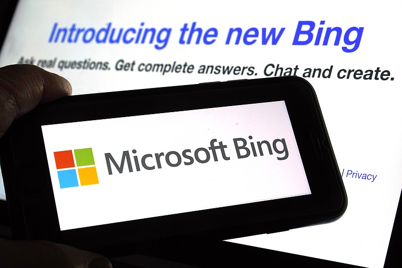 FILE - The Microsoft Bing logo and the website's page are shown in this photo taken in New York on Tuesday, Feb. 7, 2023. Microsoft is ready to take its new Bing chatbot mainstream — less than a week after making major fixes to stop the artificially intelligent search engine from going off the rails. The company said Wednesday, Feb. 22, it is bringing the new AI technology to its Bing smartphone app, as well as the app for its Edge internet browser. (AP Photo/Richard Drew)