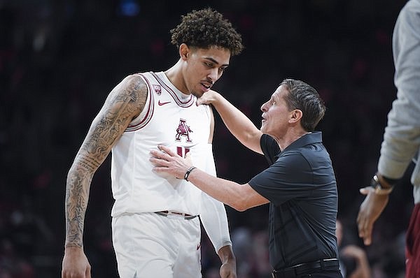 Arkansas coach Eric Musselman (right) speaks with forward Jalen Graham during a game against Georgia on Tuesday, Feb. 21, 2023, in Fayetteville.
