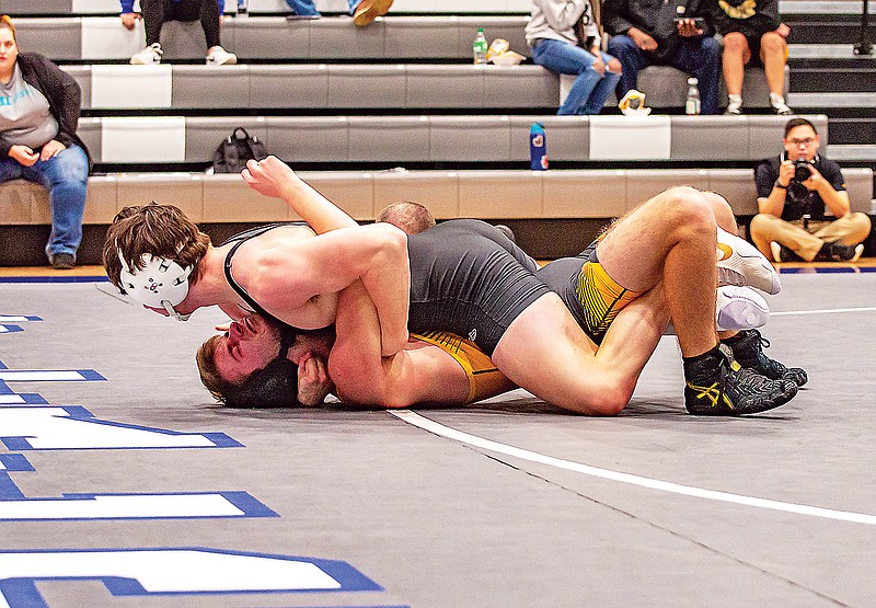 Capital City's Bishop Boyd pins Sedalia Smith-Cotton’s Morgan King during their 138-pound match this season at Capital City High School. Boyd is a state qualifier at 138 for the Cavaliers. (Ken Barnes/News Tribune)