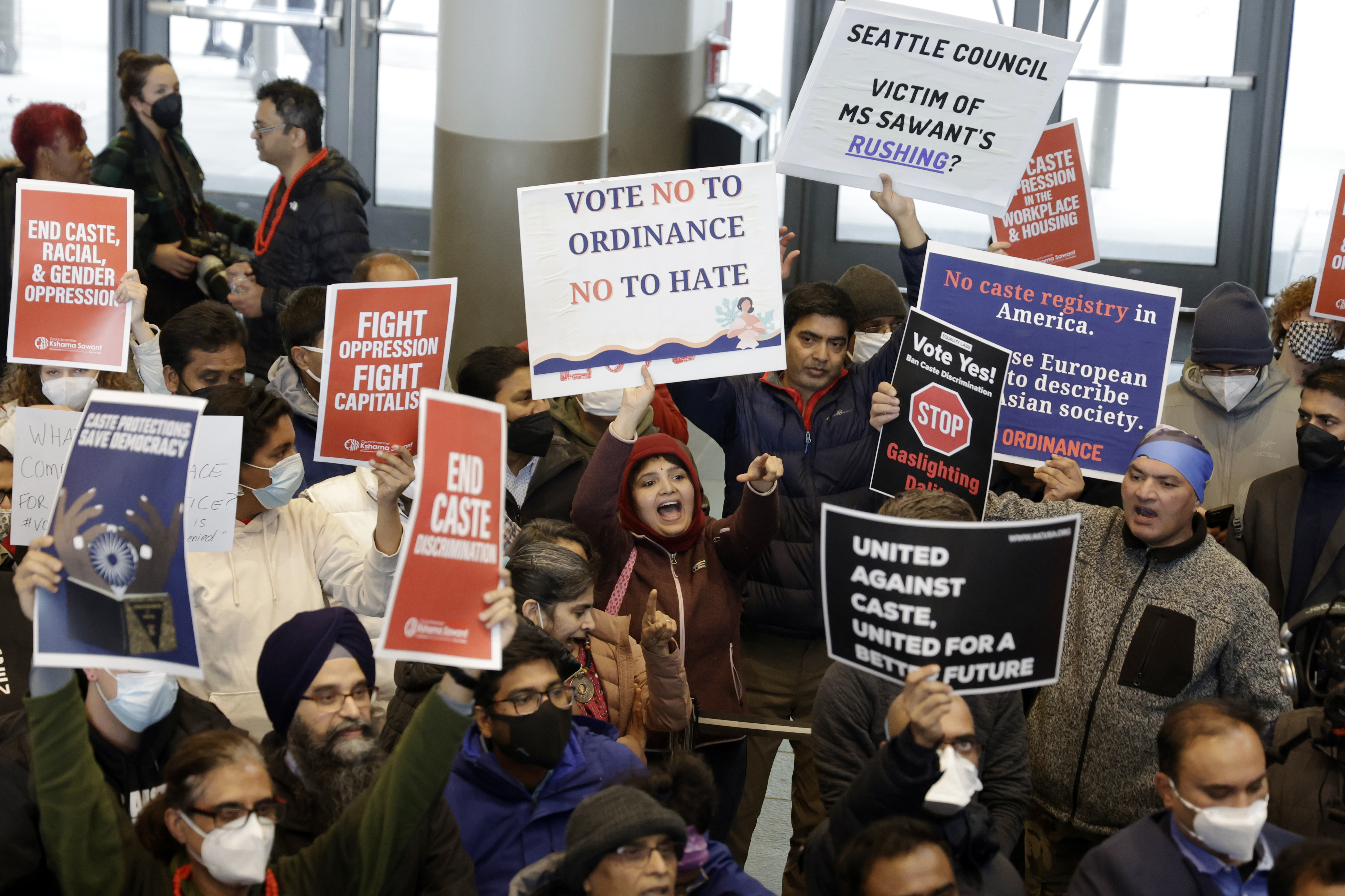 Supporters and opponents, such as Livi Nivarthi, center pointing, attempt to out yell each other during a rally at Seattle City Hall regarding a of a proposed ordinance to add caste to Seattle's anti-discrimination laws, Tuesday, Feb. 21, 2023, in Seattle. Council Member Kshama Sawant proposed the ordinance. (AP Photo/John Froschauer)