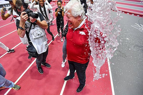 Arkansas women’s head coach Lance Harter celebrates with his team, Saturday, Feb. 25, 2023, following the Razorbacks’ championship sweep at the Southeastern Conference 2023 Indoor Track and Field Championships at the Randal Tyson Track Center in Fayetteville.