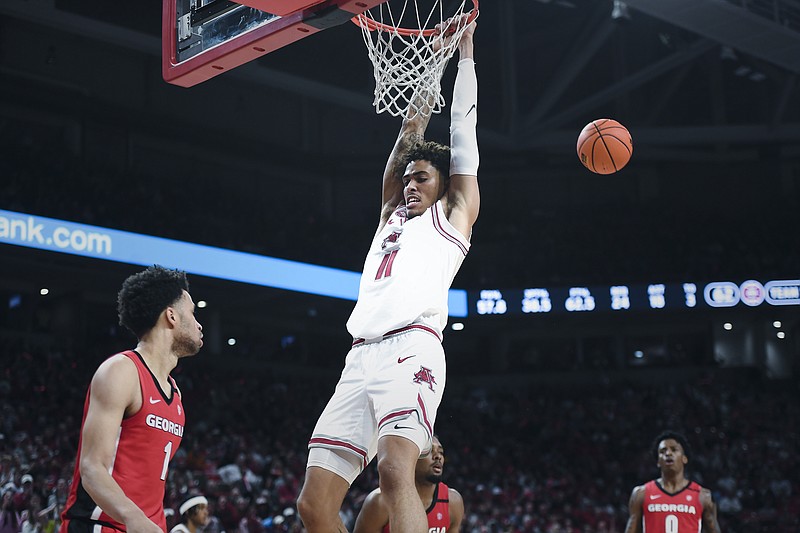 Arkansas forward Jalen Graham (11) dunks, Tuesday, February 21, 2023 during the second half of a basketball game at Bud Walton Arena in Fayetteville. (NWA Democrat-Gazette/Charlie Kaijo)