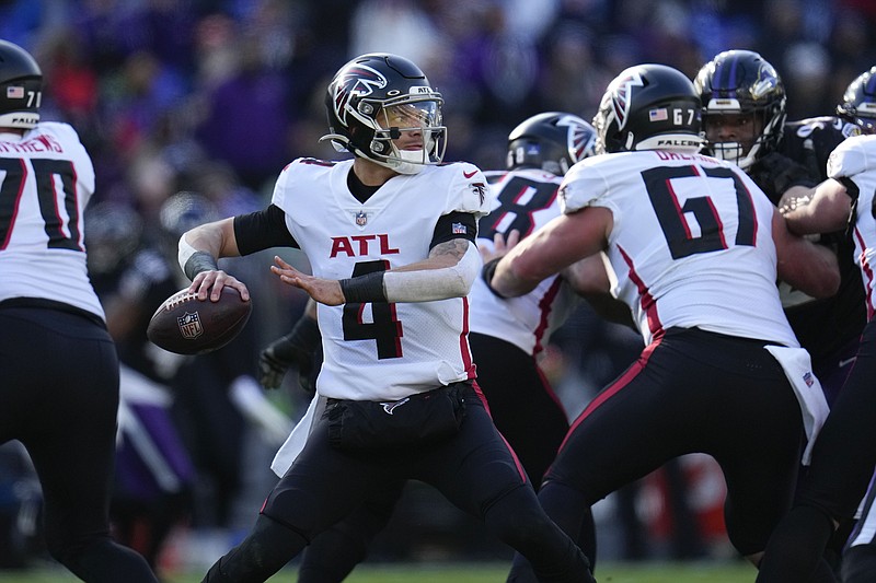 FILE -Atlanta Falcons quarterback Desmond Ridder (4) drops back to pass during the first half of an NFL football game against the Baltimore Ravens, Saturday, Dec. 24, 2022, in Baltimore. Atlanta Falcons owner Arthur Blank said Wednesday, Feb. 8, 2023 he is encouraged by the progress of quarterback Desmond Ridder and the potential of building the team around the rookie.(AP Photo/Julio Cortez, File)